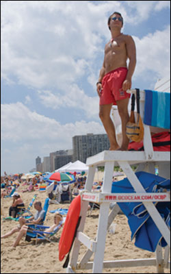 Lifeguard works from a tower chair along the Ocean City beach - by Michael W. Fincham