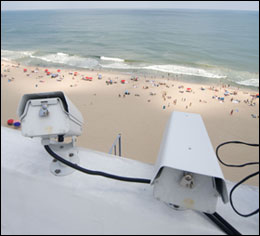 Cameras watch the beach from the rooftop at the Grand Stowaway Hotel - by Michael W. Fincham