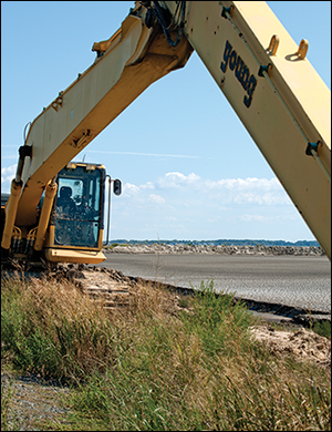 An excavator looms over Poplar Island's Cell 5b. Credit: Jeffrey Brainard