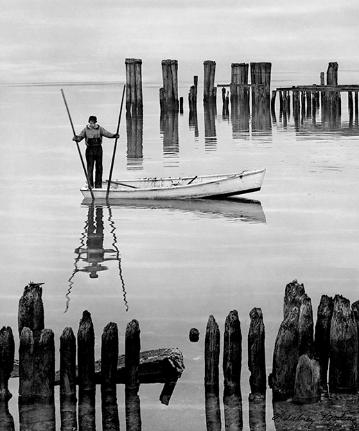 A. Aubrey Bodine got a waterman to move his skiff into position and pretend he was catching oysters. Photograph, A. Aubrey Bodine, copyright  Jennifer B. Bodine