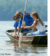 Taking a core sample by boat - by Skip Brown