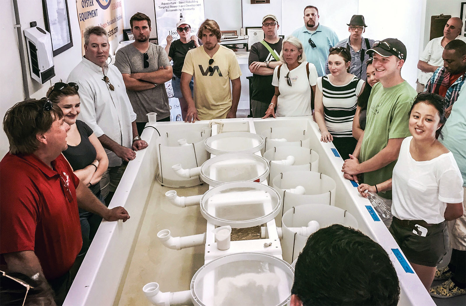 Regional chefs gather around oyster farmer Johnny Shockley (in red shirt) at Chesapeake Gold, his oyster farm on Hooper’s Island, where he shows them his oyster nursery. Steve Vilnit, formerly with Department of Natural Resources and now with Capital Seafood, organizes trips so chefs can meet watermen. Photo courtesy of Steve Vilnit