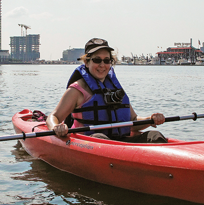 Rona Kobell paddles Baltimore’s Inner Harbor. Photo, courtesy of Rona Kobell