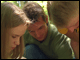 Adam Frederick with two students examining the wildlife