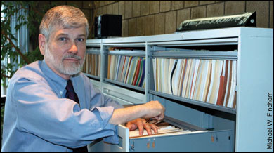Glenn Morris in his office by file cabinets - by Michael W. Fincham