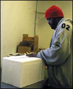 A worker readies a package for shipping, photograph by Erica Goldman
