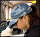 student looking in microscope while on a research cruise