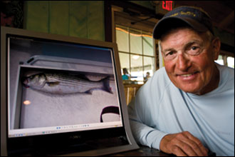 Ed Liccone with striped bass by Michael W. Fincham