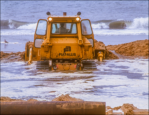 A bulldozer arranges sand. Photograph: David Harp,