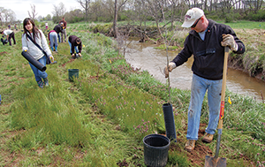 Volunteers plant trees beside Tuscarora Creek. Credit: Chesapeake Bay Foundation