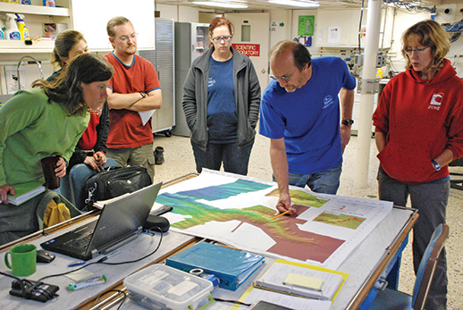 Project co-leaders Steve Ross and Sandra Brooke, identified locations on a canyon map for submersible dives. Credit: NOAA-OER/BOEM/USGS