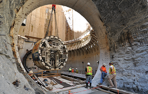 Pieces of a giant tunnel-boring machine are lowered and assembled underground. Credit: DC Water