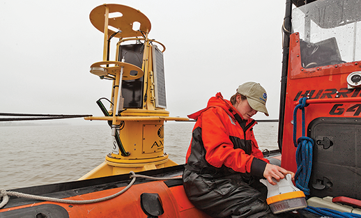 Katie Kirk servicing a buoy. Photograph courtesy Chesapeake Bay Program