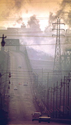 Dark clouds of factory smoke obscure Clark Avenue Bridge in Cleveland, Ohio, in 1973. Photograph, Frank J. Aleksandrowicz, National Archives and Records Administration collection