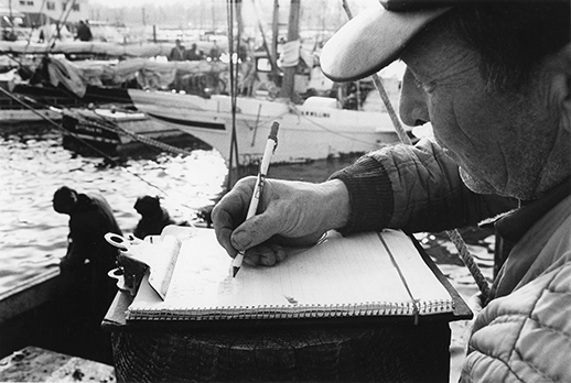 An oyster buyer records a day's catch. Photograph courtesy of the Chesapeake Bay Maritime Museum