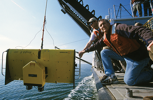 Oceanographer Bill Boicourt and research assistant Tom Wazniak lower a sampling device called a ScanFish. Photograph, Michael W. Fincham