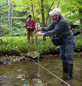 Image of Keith Eshleman standing in stream with scientific instrument.