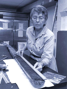 Grace Brush examining a sediment core in her laboratory