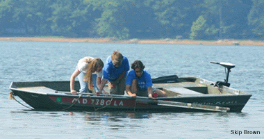 Retrieving a core by boat - by Skip Brown