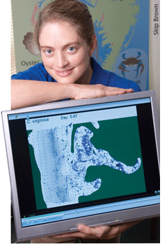 Elizabeth North holding display of oyster larvae in the Choptank River - by Skip Brown