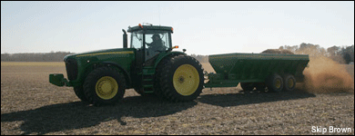Tractor plowing a field. By Skip Brown