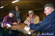 Arby Holland joins watermen (from right to left) Paul Holland, Ted Webster (standing) and Albert Hoffman - by Skip Brown